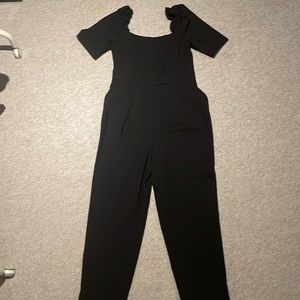 H&M black jumpsuit with ruffled top of sleeve and stretchy back, side pockets